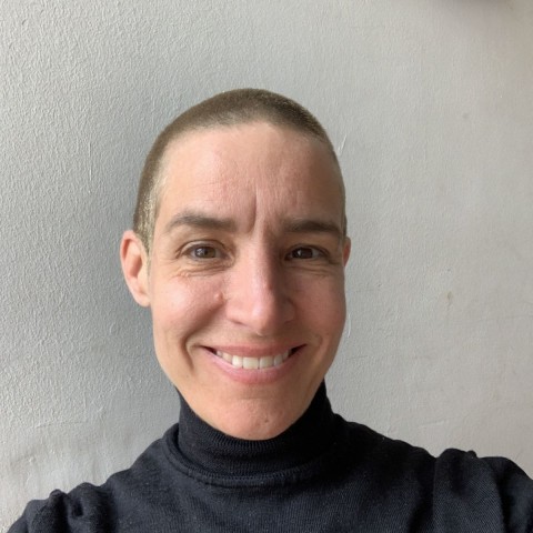 Julia Schneider with short hair smiling widely