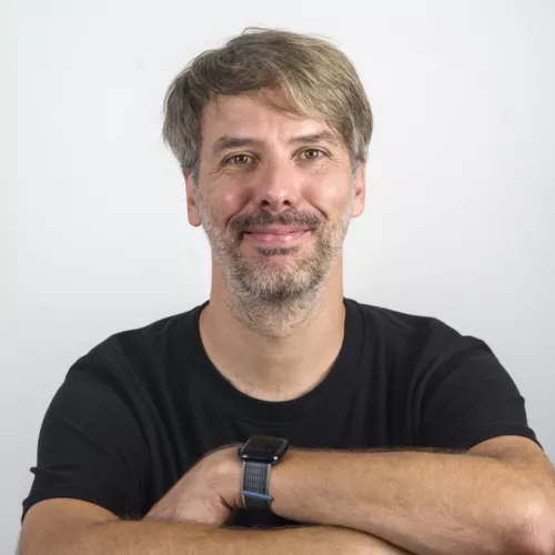 a portrait photo of a caucasian male with a beard and mixed brown / gray hair