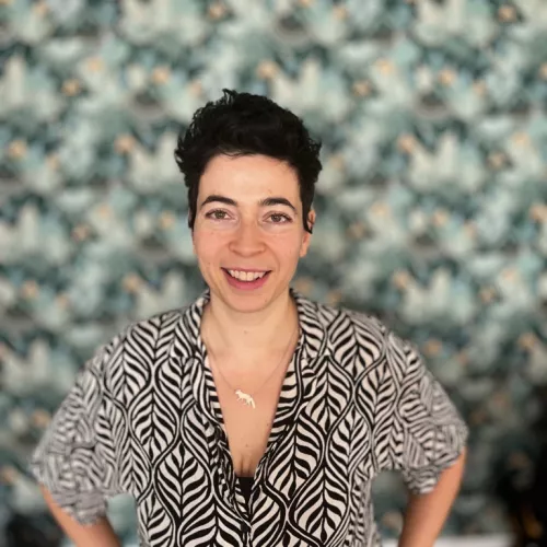 Woman with dark hair smiling into the camera