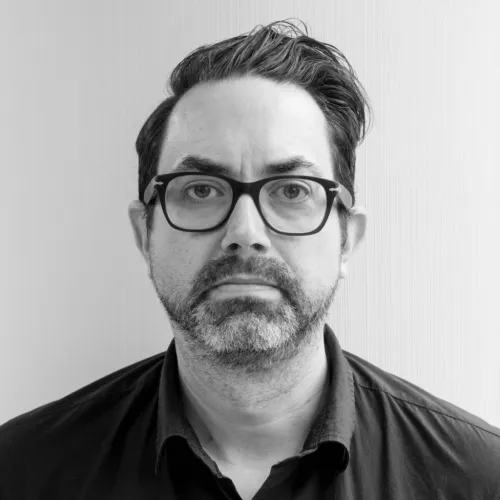 Michael Colborne with a black shirt in front of a white background
