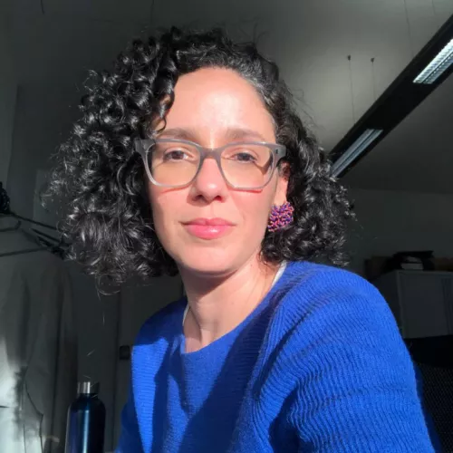 woman in blue jumper with glasses